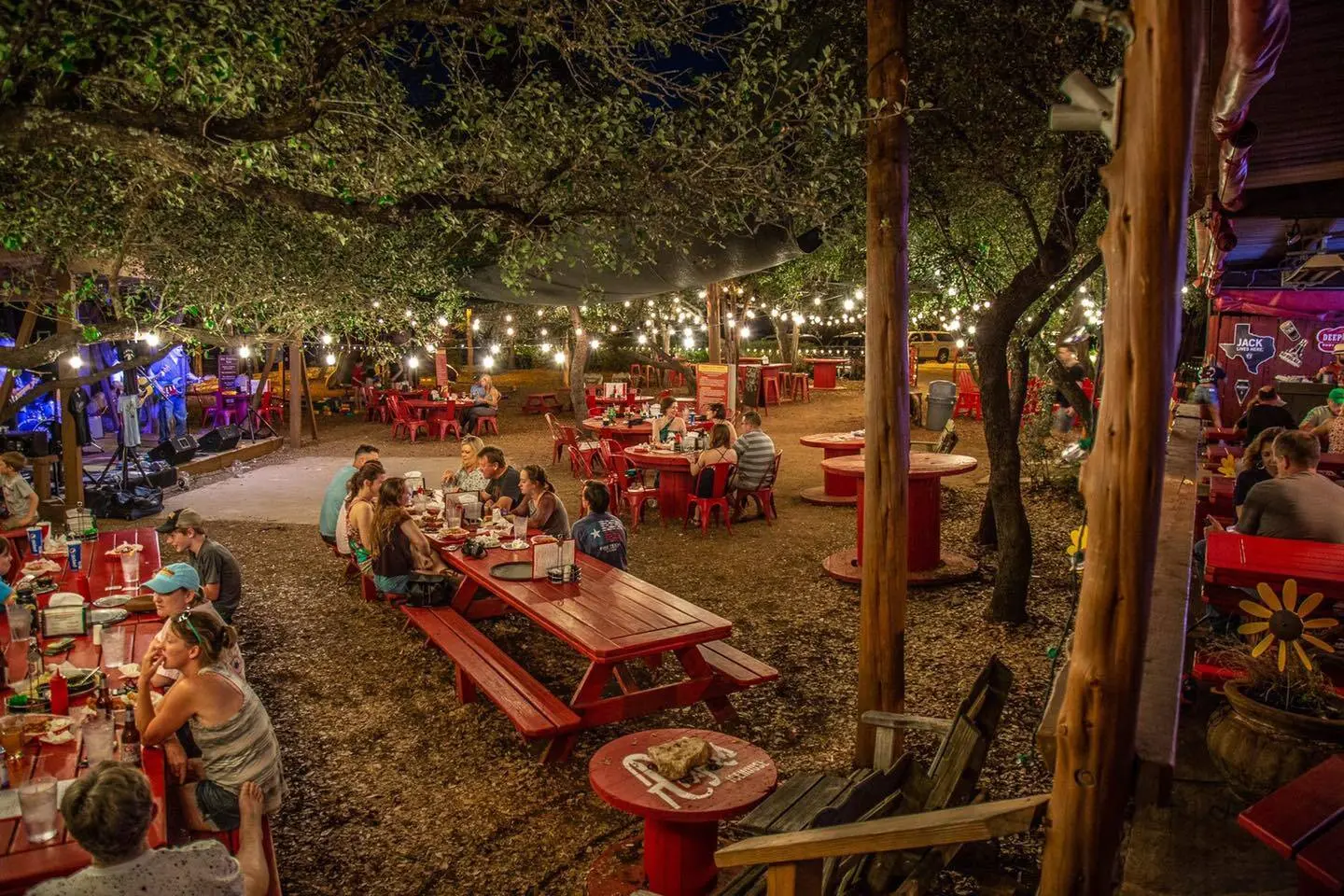 People eating at picnic tables at outdoor restaurant