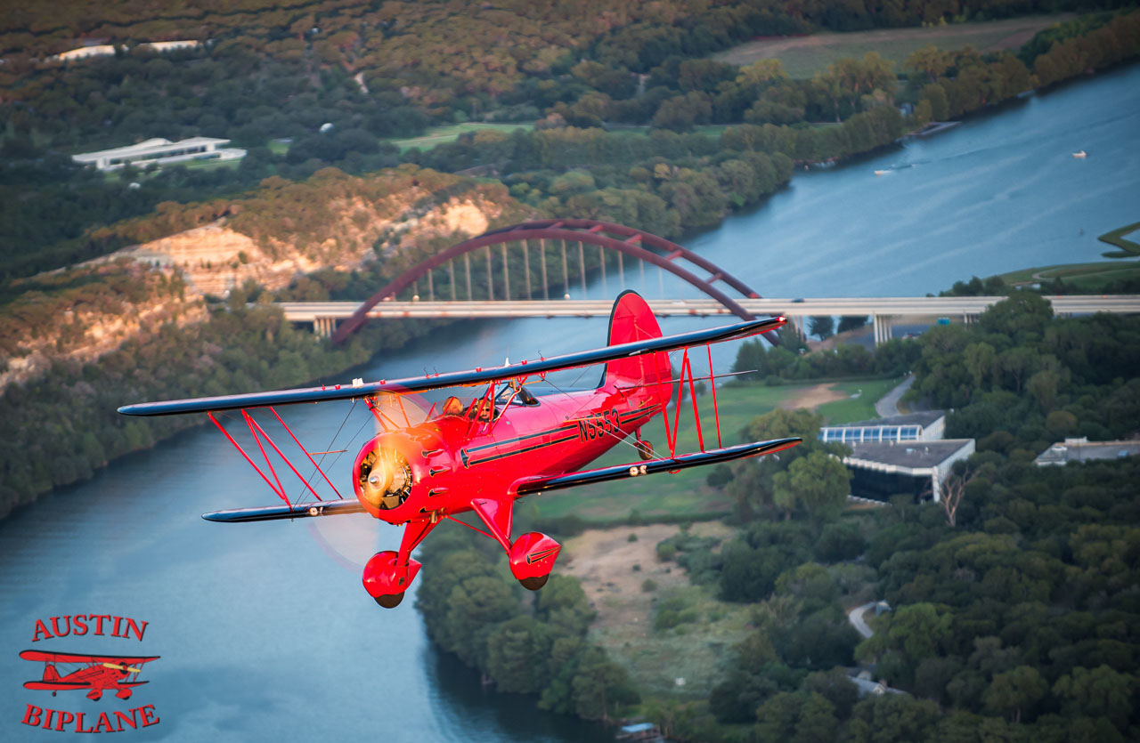 Austin Biplane Flying over the lake