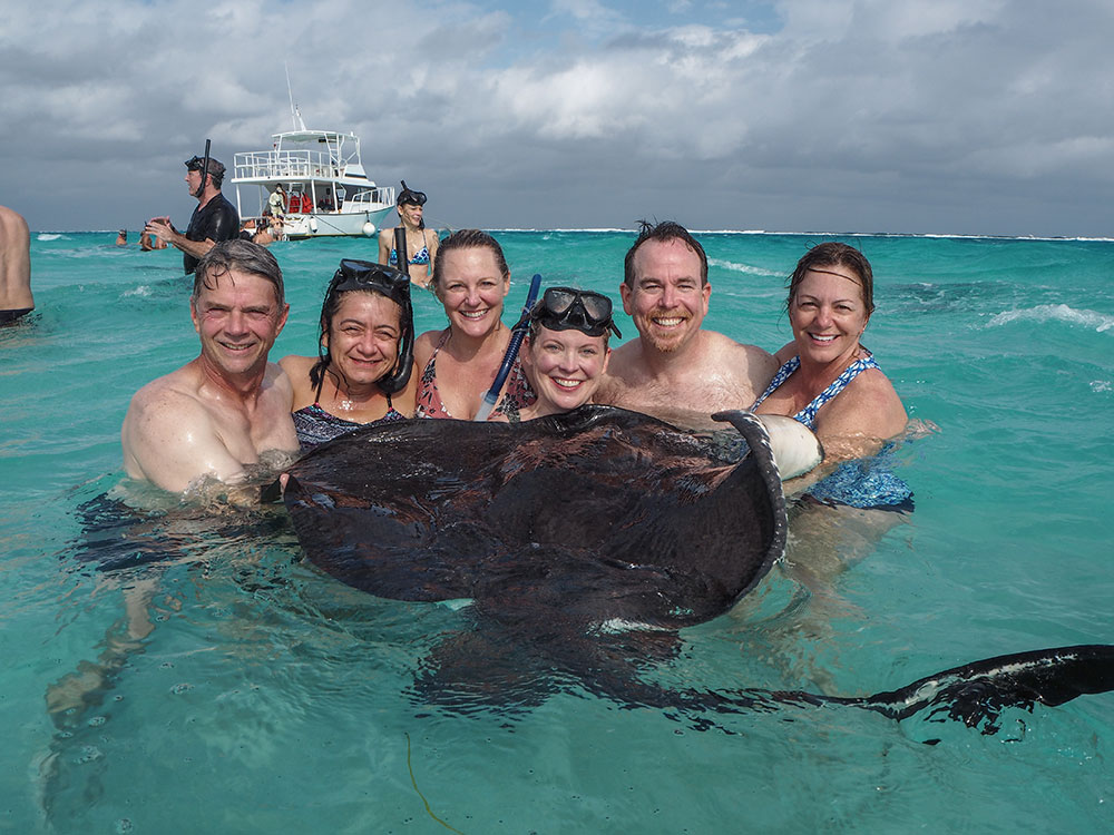 Family posing with a stingray