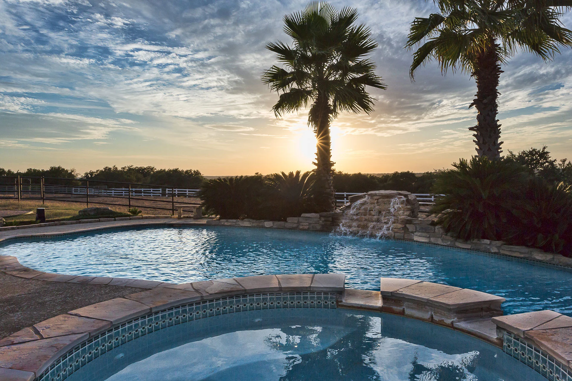 Luxury pool at sunset with palm trees