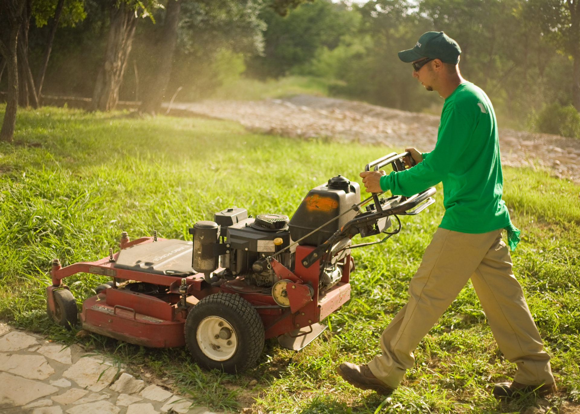 Man mowing lawn with commercial lawn mower