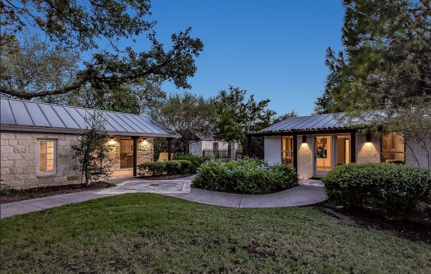 Beautiful modern homes with their lights on at dusk