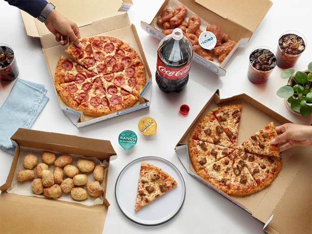 Couple enjoying pizza and garlic knots from Dominos